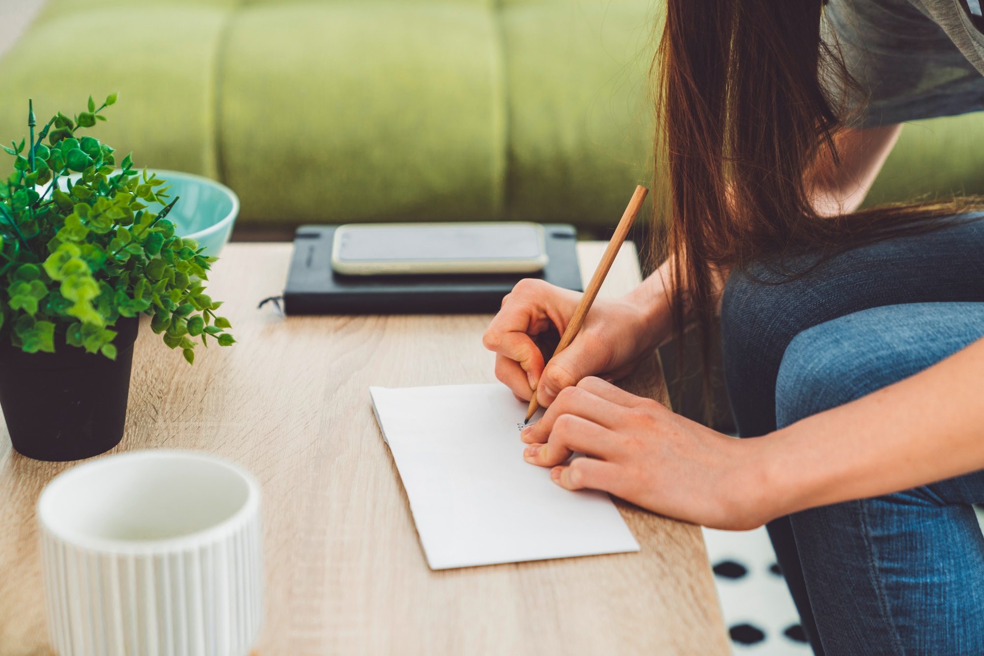 Unrecognizable woman writing address on the letter